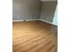 Spacious bedroom with light wood floors, grey walls, and baseboard trim at 4752 Browns Mill Ferry Rd, Lithonia, GA 30038