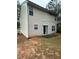 Rear exterior of home with siding, windows, and sliding glass doors leading to backyard at 4752 Browns Mill Ferry Rd, Lithonia, GA 30038