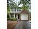 Two-story home featuring a brick accent, attached garage, and well-maintained landscaping at 4752 Browns Mill Ferry Rd, Lithonia, GA 30038
