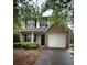 Charming two-story home featuring a brick accent wall and attached one car garage at 4752 Browns Mill Ferry Rd, Lithonia, GA 30038