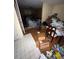 View of an open floor plan with a combination of tiled and hardwood flooring and clutter throughout at 4752 Browns Mill Ferry Rd, Lithonia, GA 30038