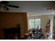 View of the open-concept living room featuring a large window and fireplace at 4752 Browns Mill Ferry Rd, Lithonia, GA 30038