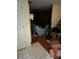 An untidy room featuring a couch, a ceiling fan, and multiple boxes at 4752 Browns Mill Ferry Rd, Lithonia, GA 30038