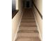 Carpeted staircase with wooden handrail and neutral-colored walls at 4752 Browns Mill Ferry Rd, Lithonia, GA 30038