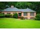 Charming one-story brick home with a well-maintained lawn and mature trees at 5346 Light Cir, Norcross, GA 30071