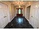 Welcoming foyer featuring dark tile flooring and a decorative front door at 5346 Light Cir, Norcross, GA 30071