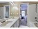 Double sinks in bathroom showing doorway to bedroom with two twin beds at 10900 Wittenridge Dr # L6, Alpharetta, GA 30022