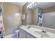 Bathroom featuring double sinks, white cabinetry and a large mirror at 10900 Wittenridge Dr # L6, Alpharetta, GA 30022
