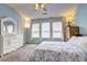Bright bedroom features a large dresser and ample natural light from multiple windows at 10900 Wittenridge Dr # L6, Alpharetta, GA 30022
