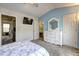 Inviting bedroom with a white dresser, soft carpet, and access to a walk-in closet at 10900 Wittenridge Dr # L6, Alpharetta, GA 30022