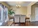 Elegant dining room with a stylish chandelier, and seating for six, adjacent to the kitchen island at 10900 Wittenridge Dr # L6, Alpharetta, GA 30022