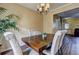 Elegant dining room featuring stylish light fixture, seating for six, and an open view to the living area at 10900 Wittenridge Dr # L6, Alpharetta, GA 30022