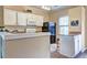 Cozy kitchen featuring white cabinets, granite countertops, and modern appliances at 10900 Wittenridge Dr # L6, Alpharetta, GA 30022