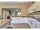 Open kitchen design features white cabinets, granite counters, and modern appliances at 10900 Wittenridge Dr # L6, Alpharetta, GA 30022
