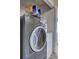Laundry room featuring a modern gray GE washer and white dryer on main level at 10900 Wittenridge Dr # L6, Alpharetta, GA 30022
