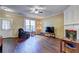 Inviting living room featuring neutral tones, hardwood floors, a cozy fireplace, and natural light through a large window at 10900 Wittenridge Dr # L6, Alpharetta, GA 30022