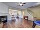 Living room boasting a fireplace, wood floors, and a staircase leading to upper levels with a view into the dining area at 10900 Wittenridge Dr # L6, Alpharetta, GA 30022