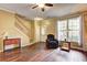 Comfortable living room showcasing hardwood floors, neutral paint, and a staircase with natural light at 10900 Wittenridge Dr # L6, Alpharetta, GA 30022