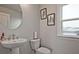 Modern bathroom features a stylish pedestal sink and a well lit window at 1149 Ansel Nw Ln, Atlanta, GA 30318