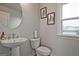 Half bath featuring a modern sink with chrome fixtures and elegant botanical themed artwork on the wall at 1149 Ansel Nw Ln, Atlanta, GA 30318