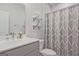 This bathroom features a single sink vanity with decorative shelving and shower with curtain at 1149 Ansel Nw Ln, Atlanta, GA 30318