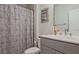 Clean, functional bathroom with shower curtain, sink, toilet, and wall art at 1149 Ansel Nw Ln, Atlanta, GA 30318