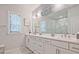 A serene bathroom with double vanity, framed mirrors, and a glass-enclosed shower at 1149 Ansel Nw Ln, Atlanta, GA 30318