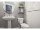 Stylish powder room with pedestal sink, floating shelves, and modern fixtures at 1149 Ansel Nw Ln, Atlanta, GA 30318