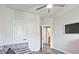 Cozy bedroom with a ceiling fan, a TV, and an ensuite bathroom entrance at 1149 Ansel Nw Ln, Atlanta, GA 30318