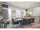 Stylish dining room featuring a modern chandelier, large windows, and seating for eight at 1149 Ansel Nw Ln, Atlanta, GA 30318