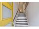 Inviting entryway with a bright yellow door and staircase leading to the upper levels at 1149 Ansel Nw Ln, Atlanta, GA 30318