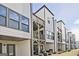 Townhome rear exterior view showcasing private patios, upper level decks, and well-maintained landscaping at 1149 Ansel Nw Ln, Atlanta, GA 30318