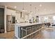 A modern kitchen island features bar seating and stainless steel appliances and is open to the dining room at 1149 Ansel Nw Ln, Atlanta, GA 30318