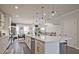 Well-lit kitchen area showcasing stainless steel appliances, a central island, and an adjacent dining space at 1149 Ansel Nw Ln, Atlanta, GA 30318