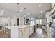 Spacious kitchen features an island with bar seating, stainless appliances, and a living area at 1149 Ansel Nw Ln, Atlanta, GA 30318