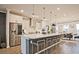 Modern kitchen with white cabinets, stainless appliances, an island with seating, and an adjacent dining area at 1149 Ansel Nw Ln, Atlanta, GA 30318