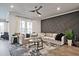 Comfortable living room featuring a plush sofa, stylish rug, modern ceiling fan, and decorative accent wall at 1149 Ansel Nw Ln, Atlanta, GA 30318