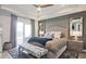 Serene main bedroom with a tray ceiling, plush bed, stylish decor, and access to a private outdoor space at 1149 Ansel Nw Ln, Atlanta, GA 30318