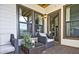 Inviting outdoor patio featuring stylish wicker furniture, a glass-topped table, and view to an open door at 1149 Ansel Nw Ln, Atlanta, GA 30318