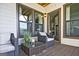 Cozy outdoor patio with wicker furniture, a glass table, and large picture windows at 1149 Ansel Nw Ln, Atlanta, GA 30318