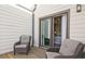 Relax on the charming patio featuring wicker chairs and a sliding glass door to bedroom at 1149 Ansel Nw Ln, Atlanta, GA 30318