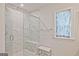 Stylish shower with glass enclosure, bench seating, and elegant marble accents at 1149 Ansel Nw Ln, Atlanta, GA 30318
