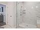 Modern, glass-enclosed shower with marble tiling and built-in shelving at 1149 Ansel Nw Ln, Atlanta, GA 30318