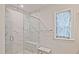 A modern shower boasting marble-style tiles, a glass door, and built-in seating at 1149 Ansel Nw Ln, Atlanta, GA 30318