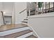 Staircase with hardwood flooring, white risers, and wrought iron railings at 1149 Ansel Nw Ln, Atlanta, GA 30318