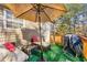 Relaxing back deck with patio furniture and an umbrella for shade, perfect for outdoor enjoyment at 120 Aspen Forest Dr, Covington, GA 30016