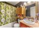 Bathroom area featuring a tub with shower, toilet, cabinet, sink and mirror at 120 Aspen Forest Dr, Covington, GA 30016