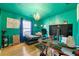 Bedroom with teal colored walls and featuring a decorative chandelier and a work station at 120 Aspen Forest Dr, Covington, GA 30016