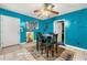 Cozy dining room featuring tile floor, modern ceiling fan, and brightly-painted accent wall at 120 Aspen Forest Dr, Covington, GA 30016