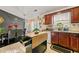 View of kitchen featuring an island, wood cabinets, granite countertops and dining table at 120 Aspen Forest Dr, Covington, GA 30016
